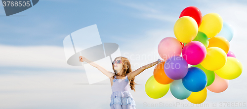 Image of happy girl with colorful balloons