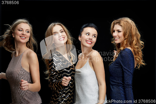 Image of happy young women dancing at night club disco