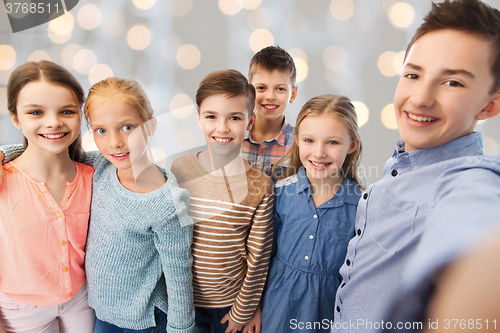 Image of happy children talking selfie