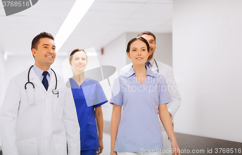 Image of happy group of medics or doctors at hospital