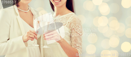 Image of close up of lesbian couple with champagne glasses