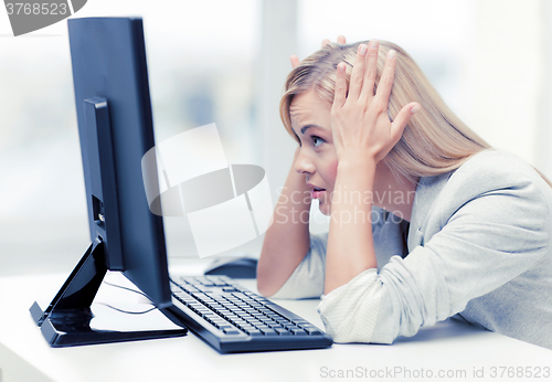 Image of stressed woman with computer