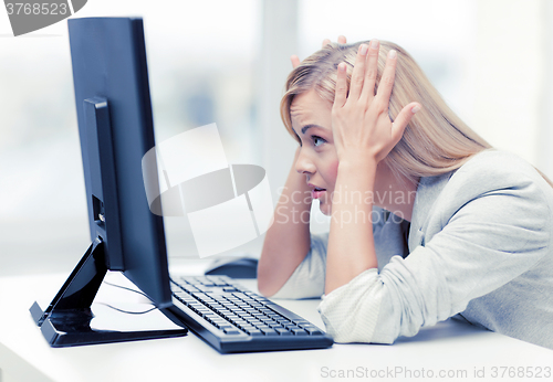 Image of stressed woman with computer