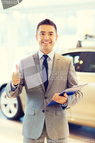 Image of happy man at auto show or car salon