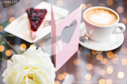 Image of close up of greeting card with heart and coffee