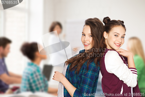 Image of happy smiling pretty teenage girls at school