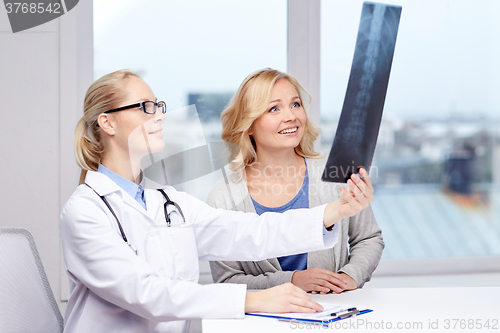 Image of woman patient and doctor with spine x-ray scan