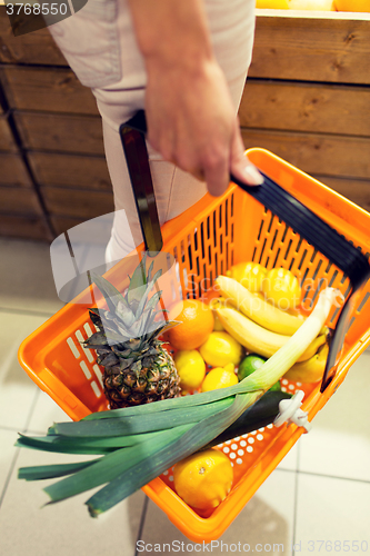 Image of close up of woman with food basket in market