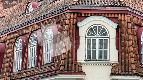 Image of Mansard windows on a tile roof of the house in Tallinn, a close 