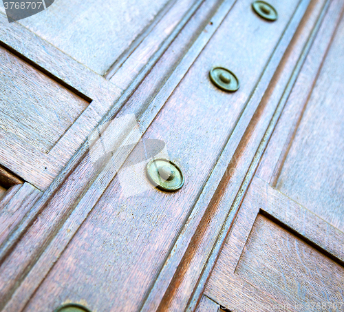 Image of in london antique brown door  rusty  brass nail and light