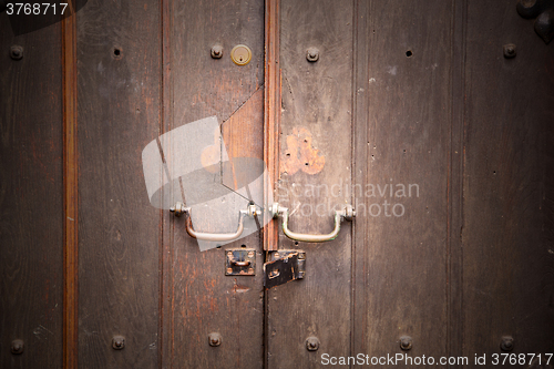 Image of handle in london antique brown door  rusty  brass nail and light