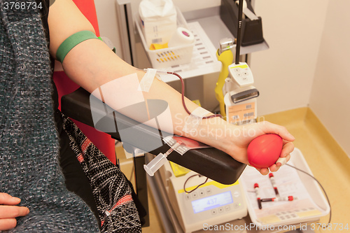 Image of Donor in an armchair donates blood