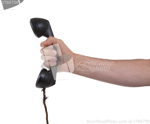 Image of Male hand holding retro landline telephone