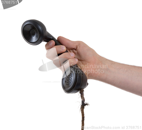 Image of Male hand holding retro landline telephone
