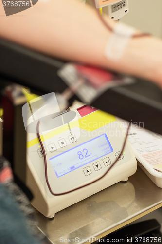 Image of Donor in an armchair donates blood,, close-up