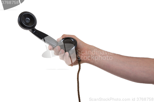 Image of Male hand holding retro landline telephone