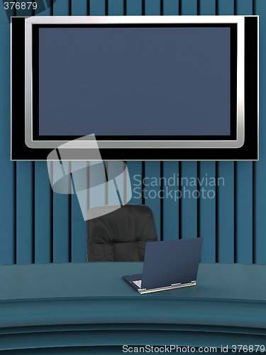 Image of Office interior with laptop and flat screen