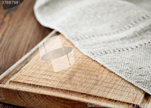 Image of wooden cutting board and linen napkin