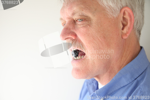 Image of Man with blueberry in mouth