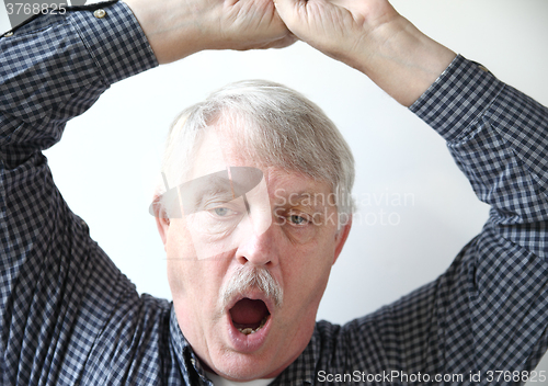 Image of Sleepy older man yawns