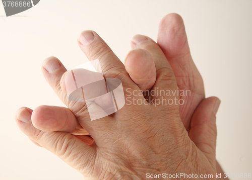 Image of Man twines fingers together.