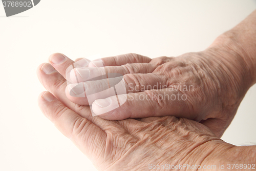 Image of Wrinkled skin on older man hands