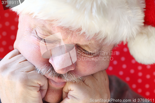 Image of Man in Santa hat looking depressed