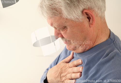 Image of Senior suffers from heartburn or chest pain