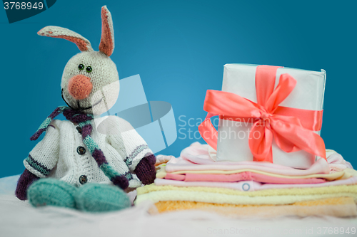 Image of The baby clothes with a  white gift box