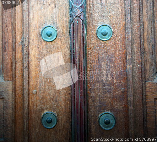 Image of in london antique brown door  rusty  brass nail and light