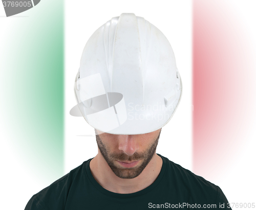 Image of Engineer with flag on background - Italy