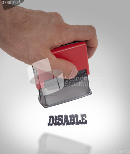 Image of Plastic stamp in hand, isolated