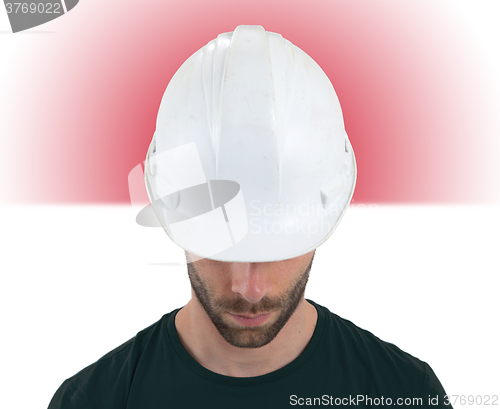 Image of Engineer with flag on background - Indonesia