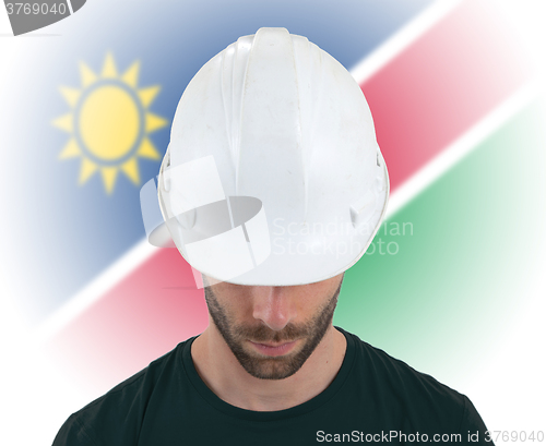 Image of Engineer with flag on background - Namibia