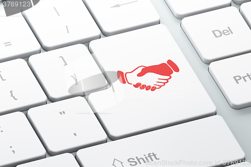 Image of Finance concept: Handshake on computer keyboard background