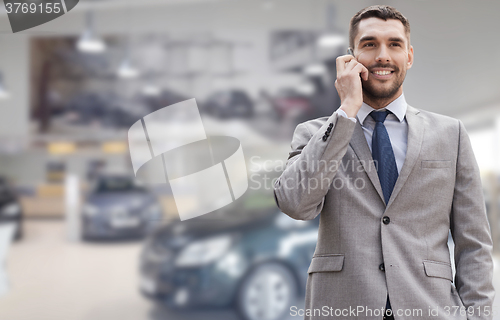 Image of smiling businessman talking on smartphone