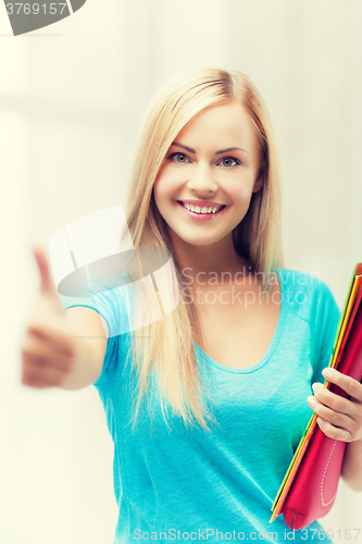 Image of smiling student with folders