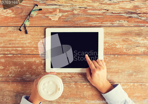 Image of close up of female hands with tablet pc and coffee