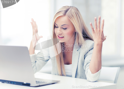 Image of angry woman with laptop