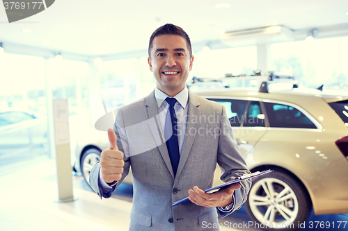 Image of happy man at auto show or car salon