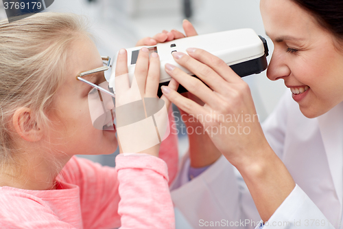 Image of optician with pupilometer and patient 