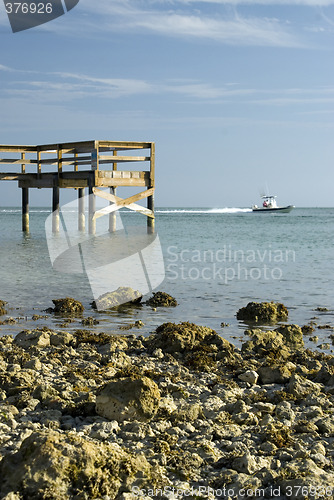 Image of pier rocky shoreline with boat