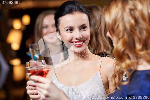 Image of happy women with drinks at night club