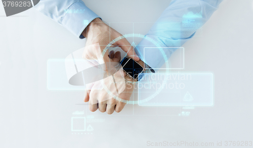 Image of hand with smartwatch and virtual screen projection
