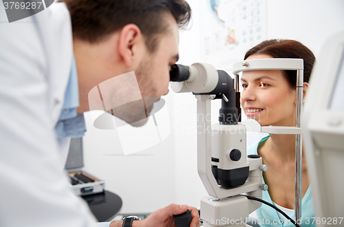 Image of optician with tonometer and patient at eye clinic