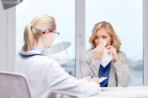 Image of doctor and ill woman patient with flu at clinic