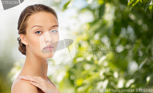 Image of smiling young woman face and shoulders