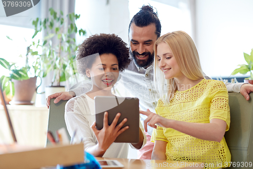 Image of happy creative team with tablet pc in office