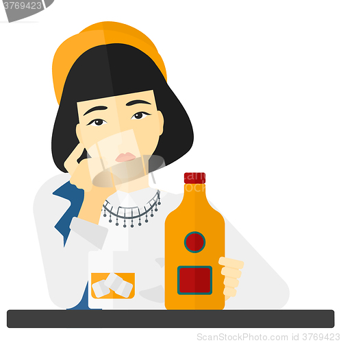 Image of Sad woman with bottle and glass.