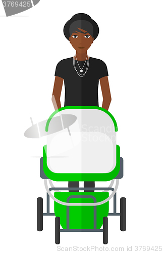 Image of Woman pushing pram.